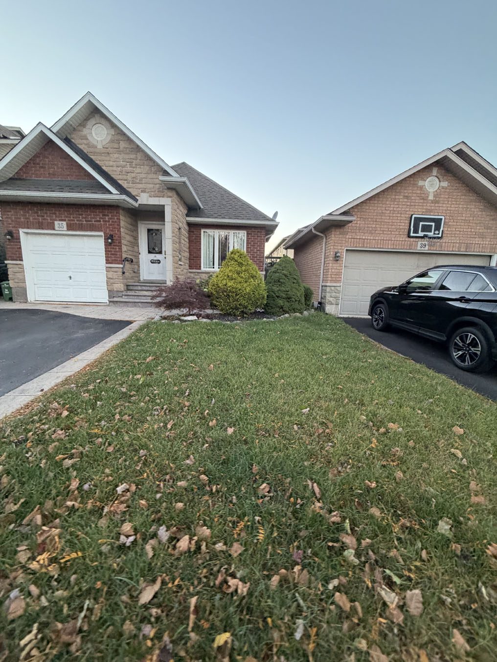 Sodded front lawn on a brick bungalow with a single garage in Hamilton