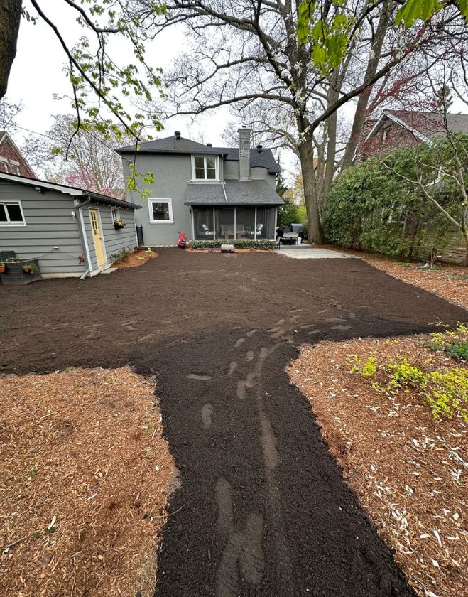 Gallery 10 A residential backyard stripped down to bare dirt with visible footprints after the old grass was removed during a sod replacement in Beasley, Hamilton.