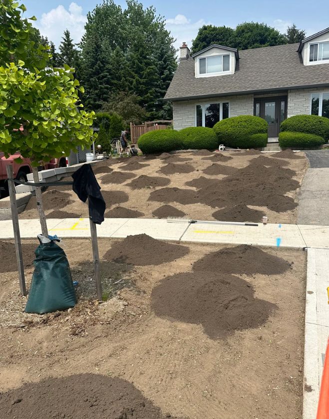 Gallery 6 Piles of fresh topsoil distributed across a bare front yard in preparation for grading and sod installation in the Stinson neighborhood of Hamilton.