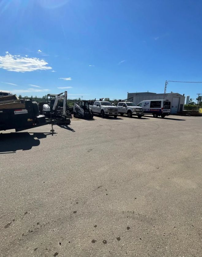 Gallery 31 A fleet of professional landscaping trucks, vans, and heavy equipment parked in a commercial yard in North Grimsby, ready for sod installation projects.