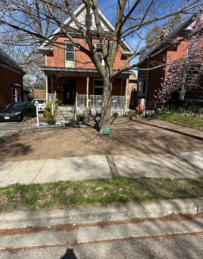 Gallery 2 A residential front yard stripped completely of its old grass down to bare dirt during a lawn replacement project in Corktown, Hamilton.