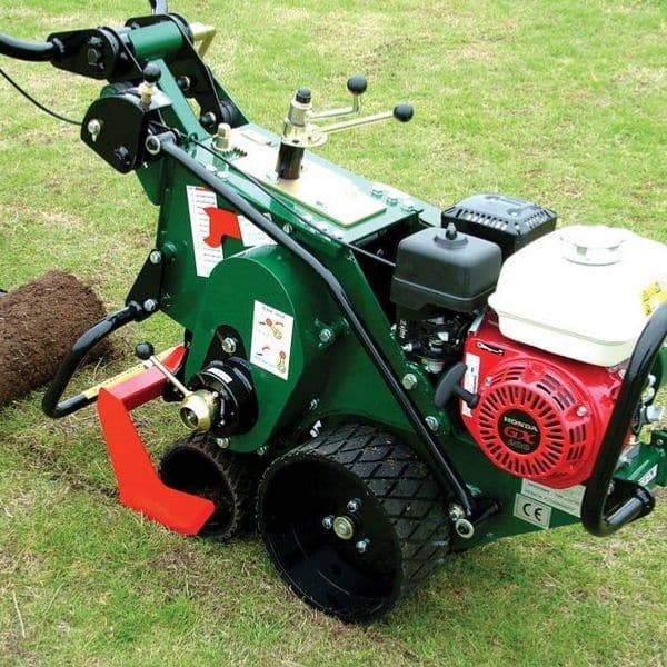 A green motorized Honda sod cutter machine resting on a lawn, used for professional grass removal in Hamilton.