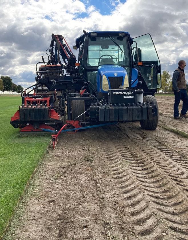 Gallery 28 A blue tractor equipped with a professional sod harvesting attachment operating in a turf field to supply the Grimsby area.