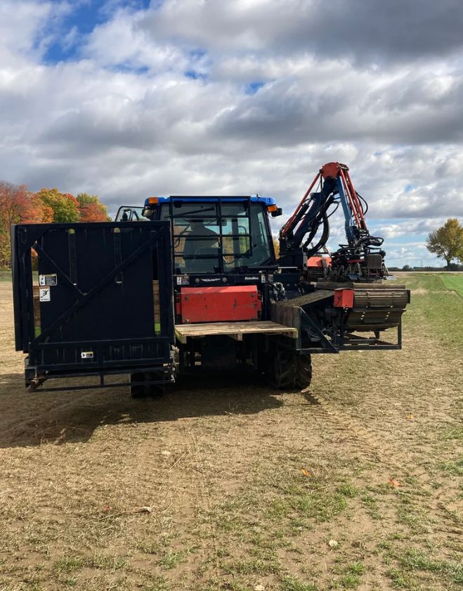 Gallery 25 A blue sod harvesting tractor in a field preparing fresh turf for delivery to residential landscaping projects in Downtown Grimsby, Ontario.